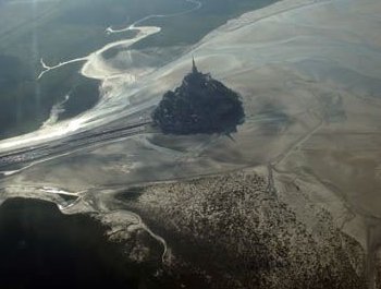 Véronique Jannot et Priscilla Telmon sautent avec un drapeau tibétain au-dessus du Mont St-Michel